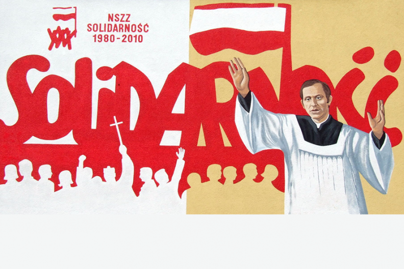 Mural upamiętniający trzydziestą rocznicę powstania NSZZ Solidarność z podobizną ks. Popiełuszki, znajdujący się na budynku lokalnej siedziby związku w Ostrowcu Świętokrzyskim, fot. Wikipedia.